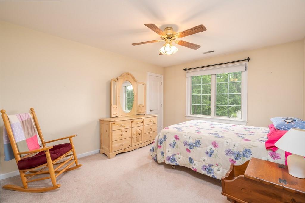 45 Gilbert Road Southampton, MA 01073 - Photo 21 of 36 a bedroom with a bed a chandelier and dresser