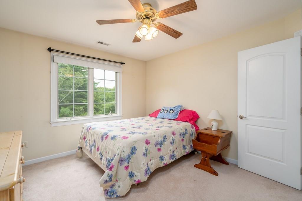 45 Gilbert Road Southampton, MA 01073 - Photo 22 of 36 a bedroom with a bed and a chandelier