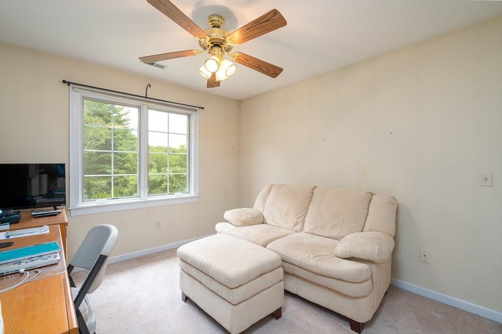 45 Gilbert Road Southampton, MA 01073 - Photo 24 of 36 a living room with furniture a flat screen tv and a large window