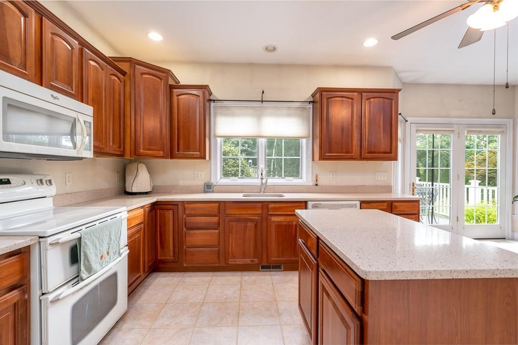 45 Gilbert Road Southampton, MA 01073 - Photo 6 of 36 a kitchen with stainless steel appliances granite countertop a sink stove and cabinets