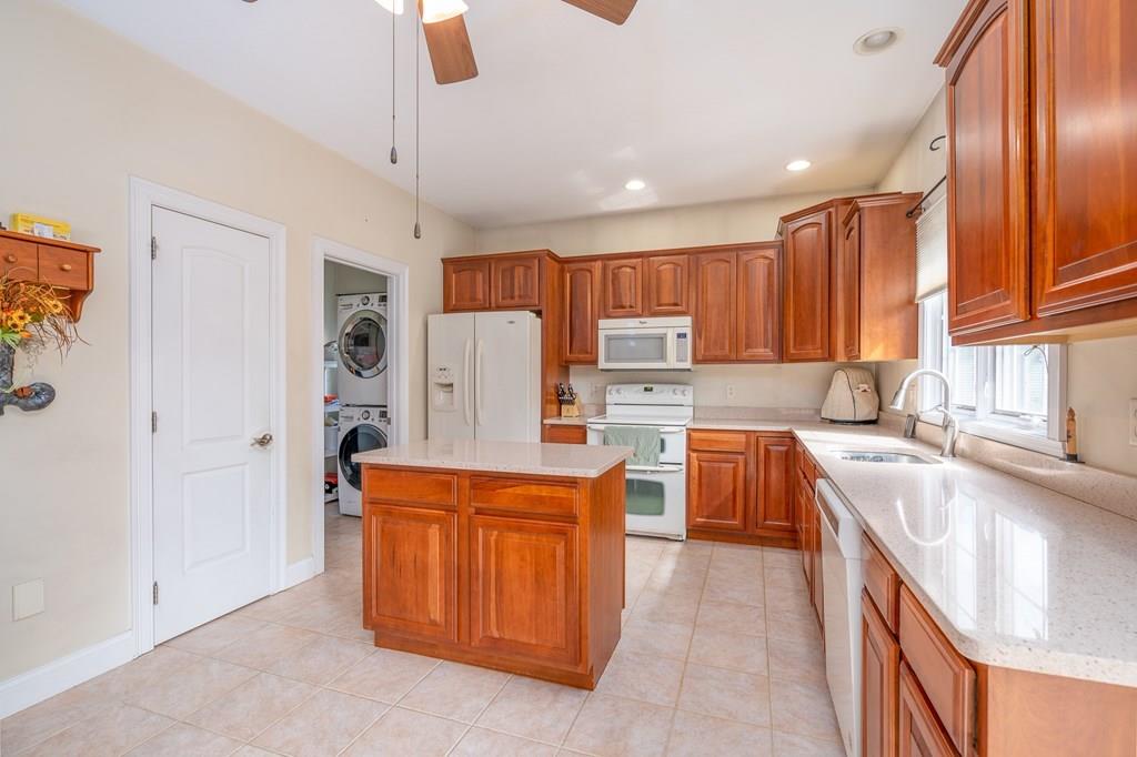 45 Gilbert Road Southampton, MA 01073 - Photo 7 of 36 a kitchen with stainless steel appliances granite countertop a refrigerator a sink dishwasher and a stove with wooden cabinets