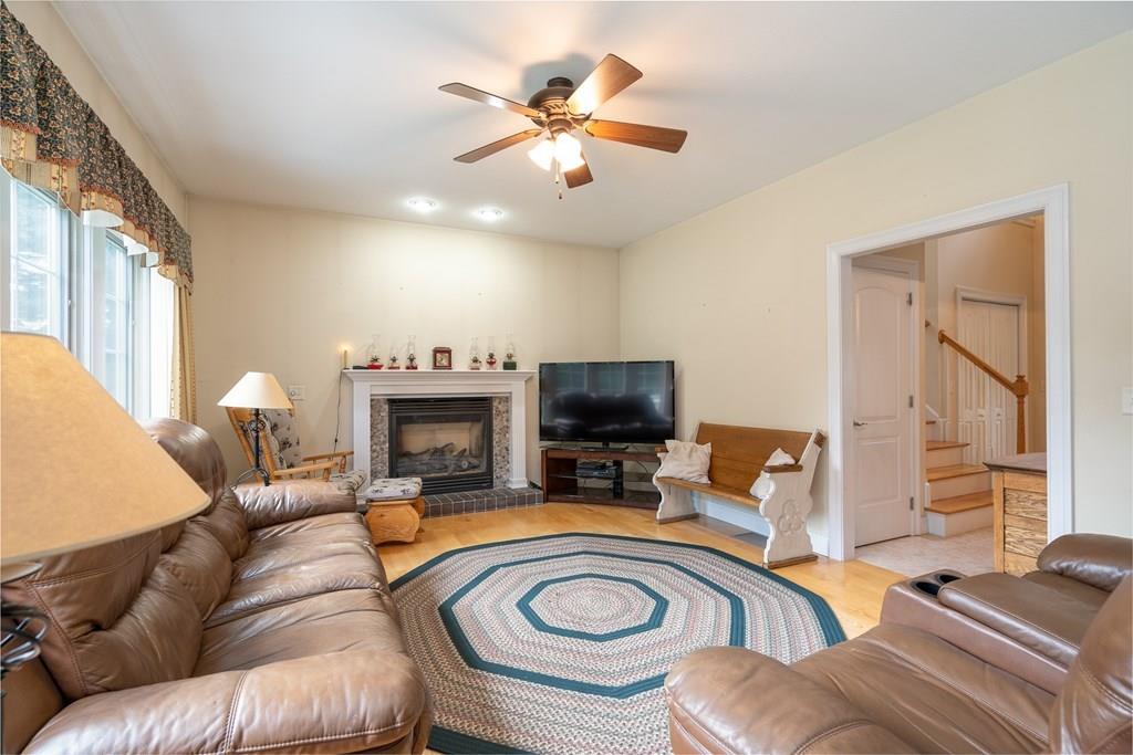 45 Gilbert Road Southampton, MA 01073 - Photo 10 of 36 a living room with furniture a fireplace and a flat screen tv