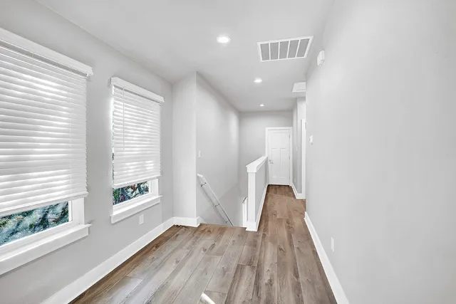 a view of a room with wooden floor and window