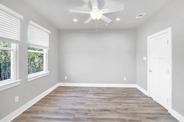 wooden floor in an empty room with a window