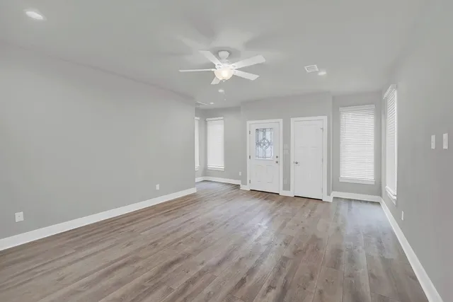 wooden floor in an empty room with a window