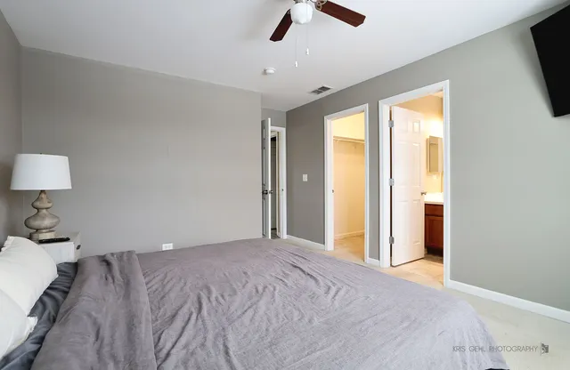 a bedroom with a large bed and a large window