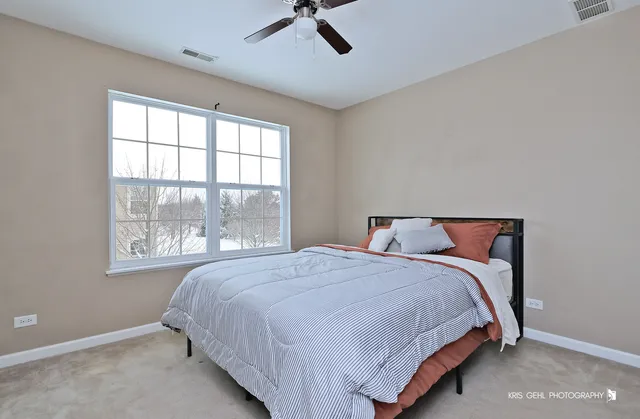a bedroom with a bed and window