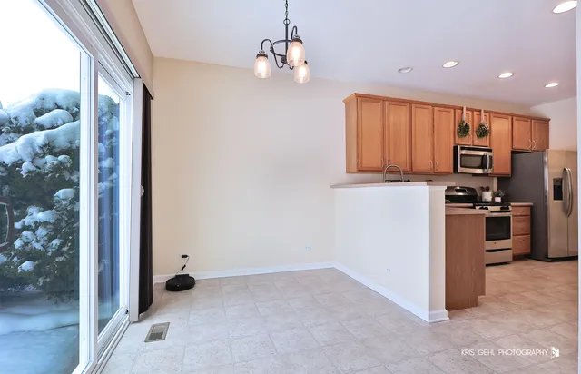 a view of kitchen with sink refrigerator and wooden floor