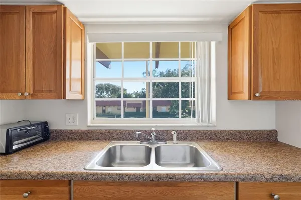a kitchen with granite countertop a sink and a window