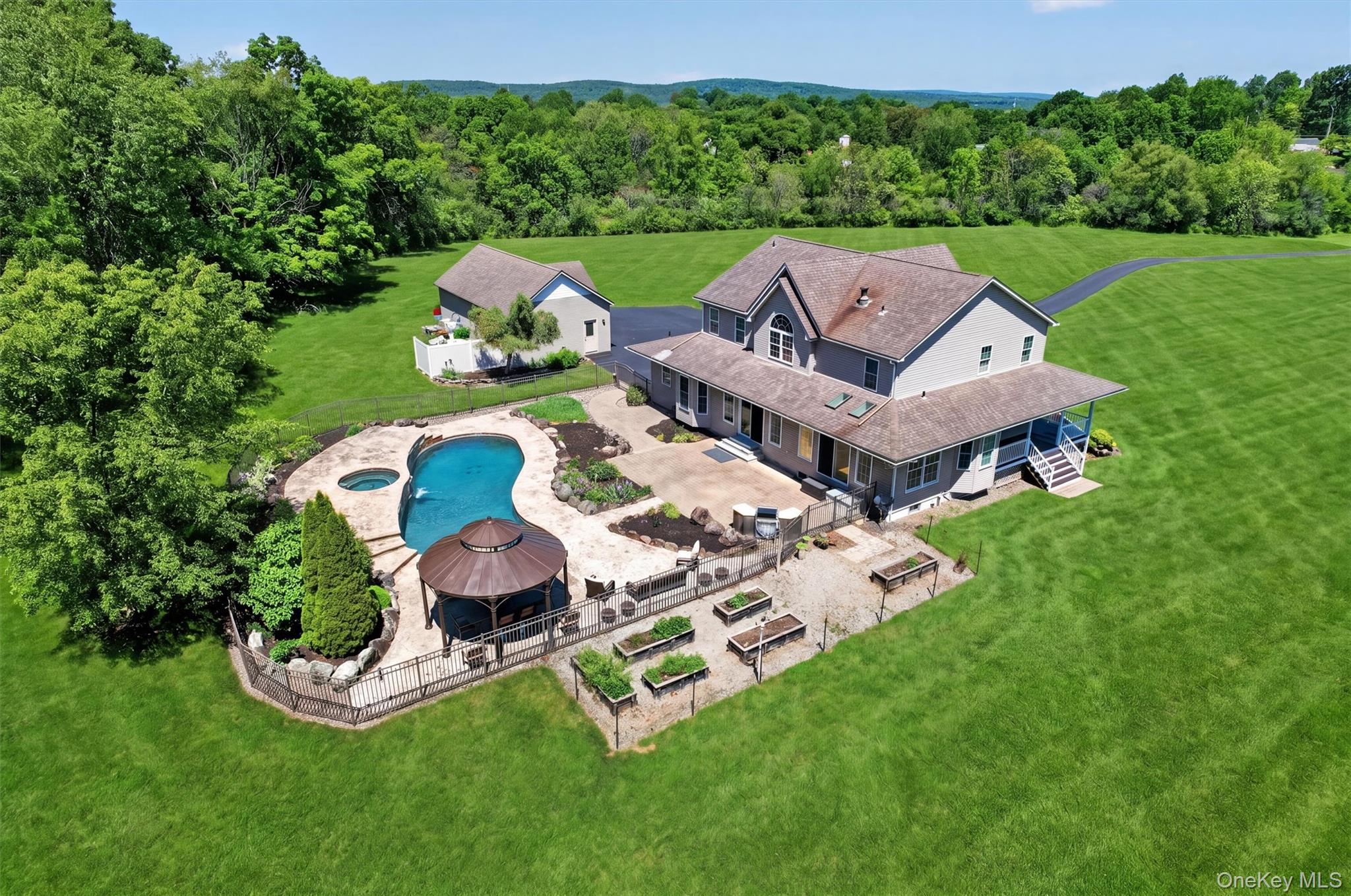 954 Ridgebury Road New Hampton, NY 10958 - Photo 41 of 45 This aerial view captures how beautifully the home, pool, patio, gardens, garage, and open lawn all come together into one peaceful setting.
