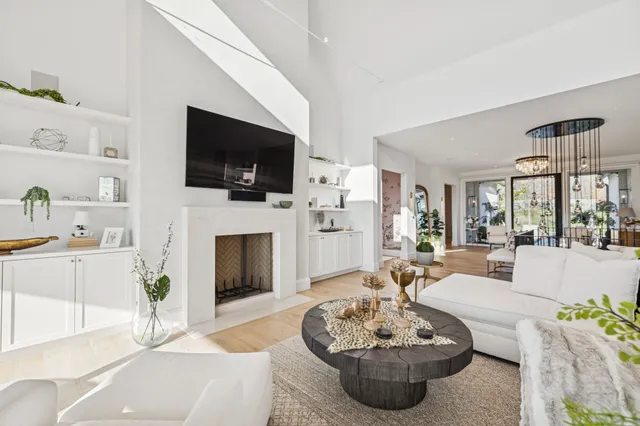 a living room with fireplace furniture and a flat screen tv
