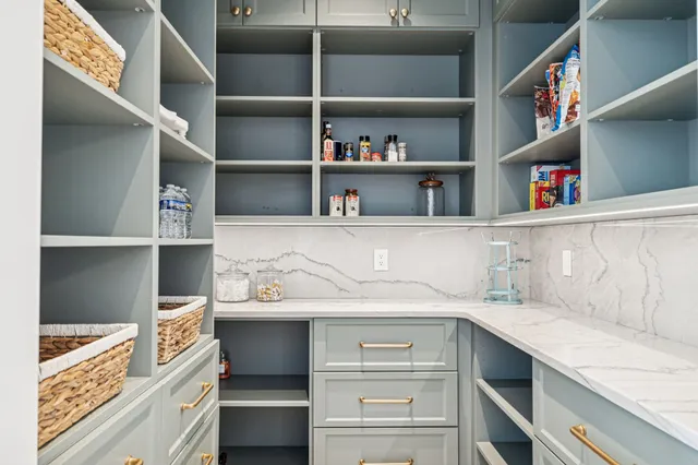 a view of walk in closet with clothes