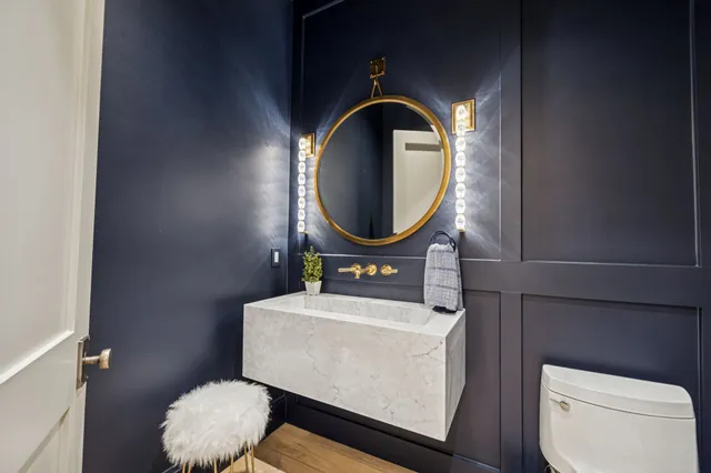 a kitchen with white cabinets and sink