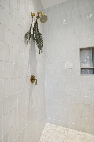 a large bed sitting in a bedroom next to a window