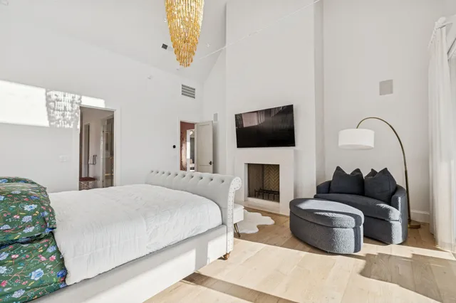 a bedroom with a bed and a chandelier