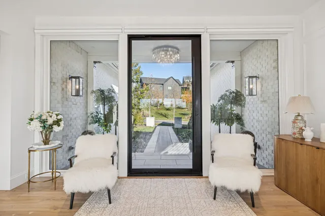 a view of a porch with a table and chairs