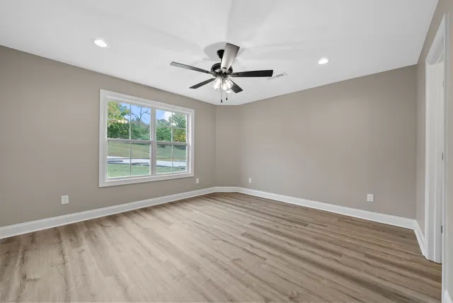 wooden floor in an empty room with a window