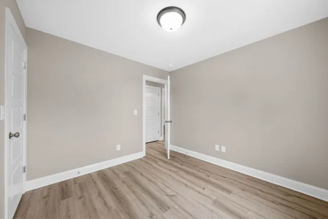 a view of room with wooden floor