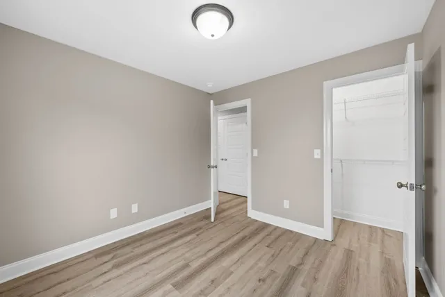 a view of an empty room with wooden floor