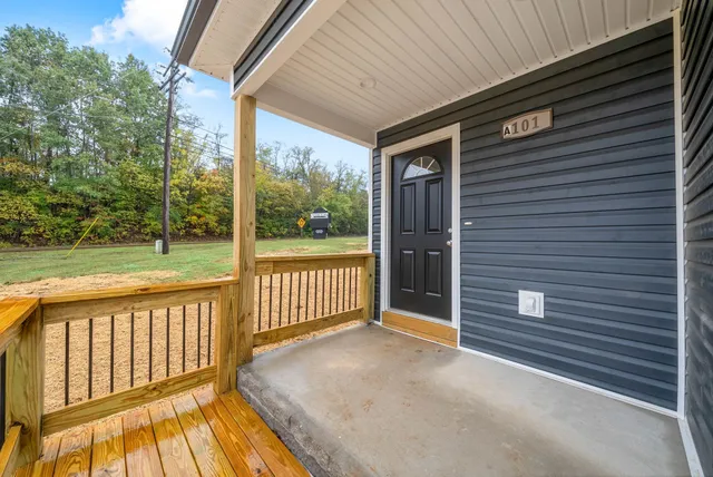 a view of a porch with wooden floor and fence