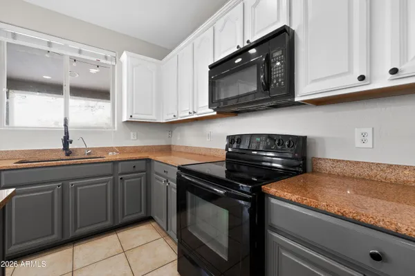 a kitchen with stainless steel appliances granite countertop a sink stove and microwave