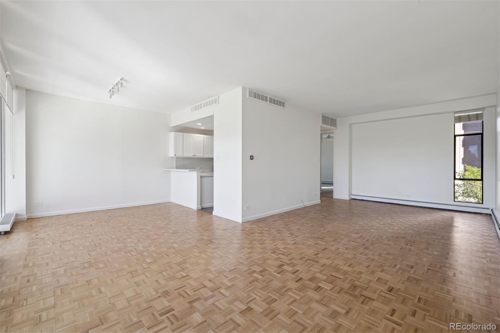 1201 North Williams Street, Unit 2A Denver, CO 80218 - Photo 11 of 29 a view of an empty room with window and wooden floor