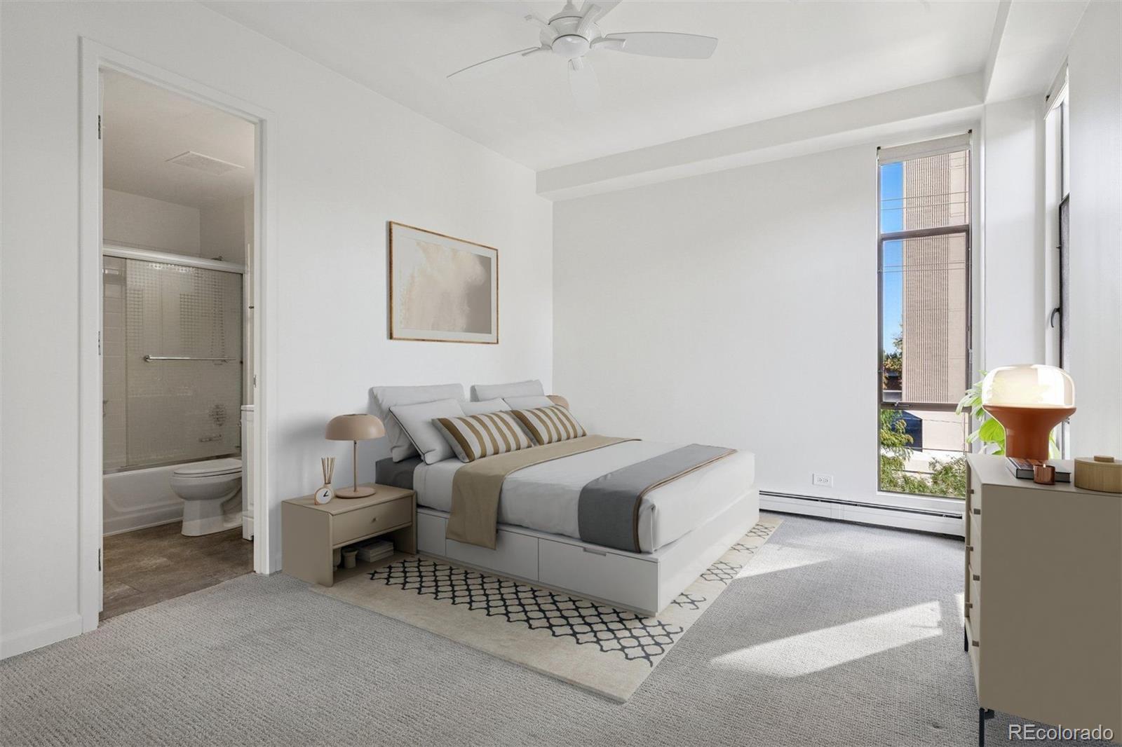1201 North Williams Street, Unit 2A Denver, CO 80218 - Photo 18 of 29 a spacious bedroom with a bed and a chandelier