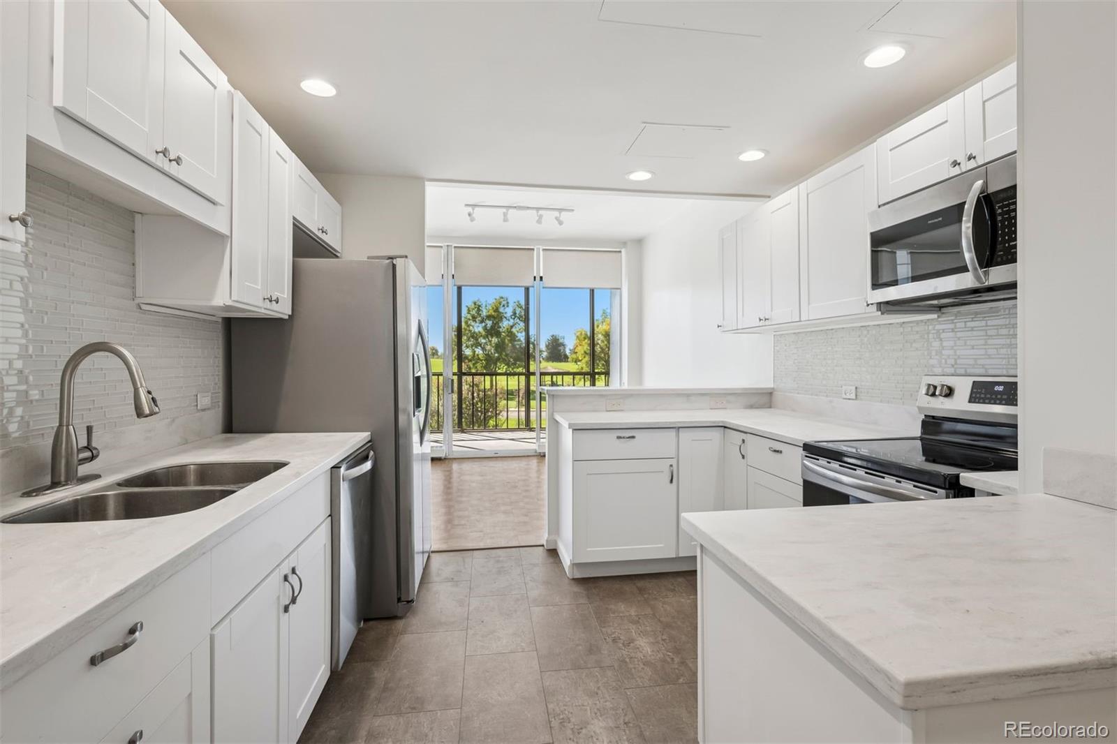 1201 North Williams Street, Unit 2A Denver, CO 80218 - Photo 6 of 29 a kitchen that has a sink and a stove top oven