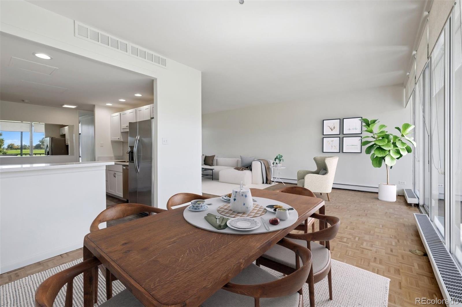 1201 North Williams Street, Unit 2A Denver, CO 80218 - Photo 10 of 29 a view of a dining room with furniture and a potted plant