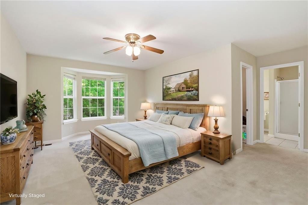12 Whispering Pines Northeast Rome, GA 30161 - Photo 23 of 57 a spacious bedroom with a large bed and a flat screen tv