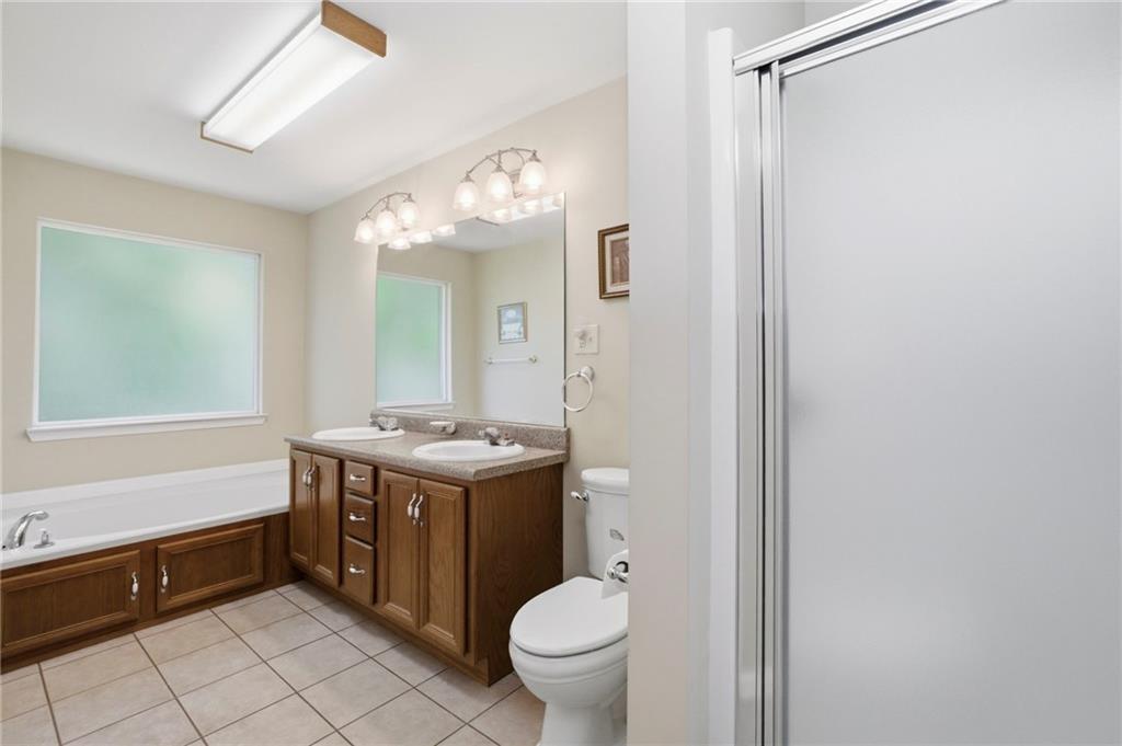 12 Whispering Pines Northeast Rome, GA 30161 - Photo 29 of 57 a bathroom with a granite countertop sink mirror vanity and toilet