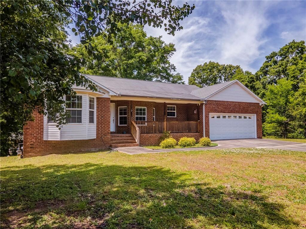12 Whispering Pines Northeast Rome, GA 30161 - Photo 3 of 57 a front view of a house with yard and green space