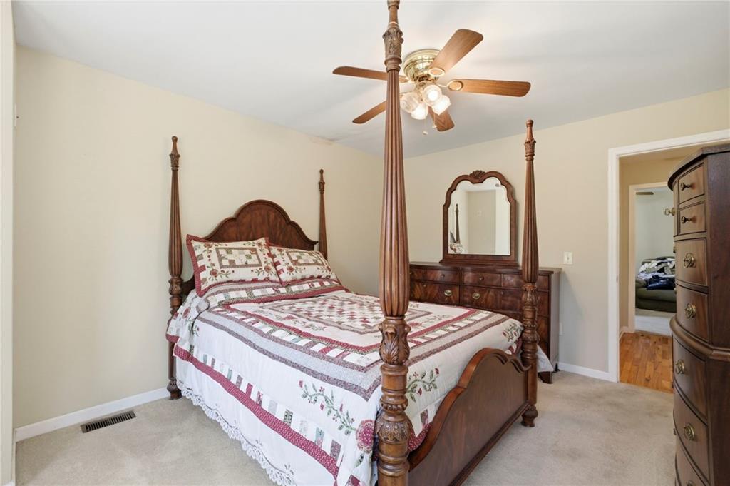 12 Whispering Pines Northeast Rome, GA 30161 - Photo 32 of 57 a bedroom with a bed a chandelier and dresser