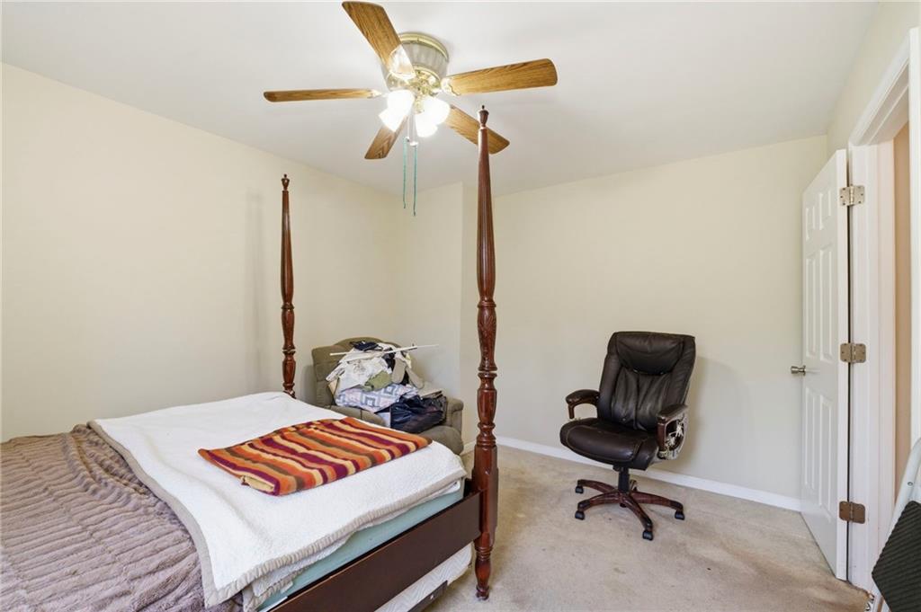 12 Whispering Pines Northeast Rome, GA 30161 - Photo 34 of 57 a bedroom with a bed and a chandelier
