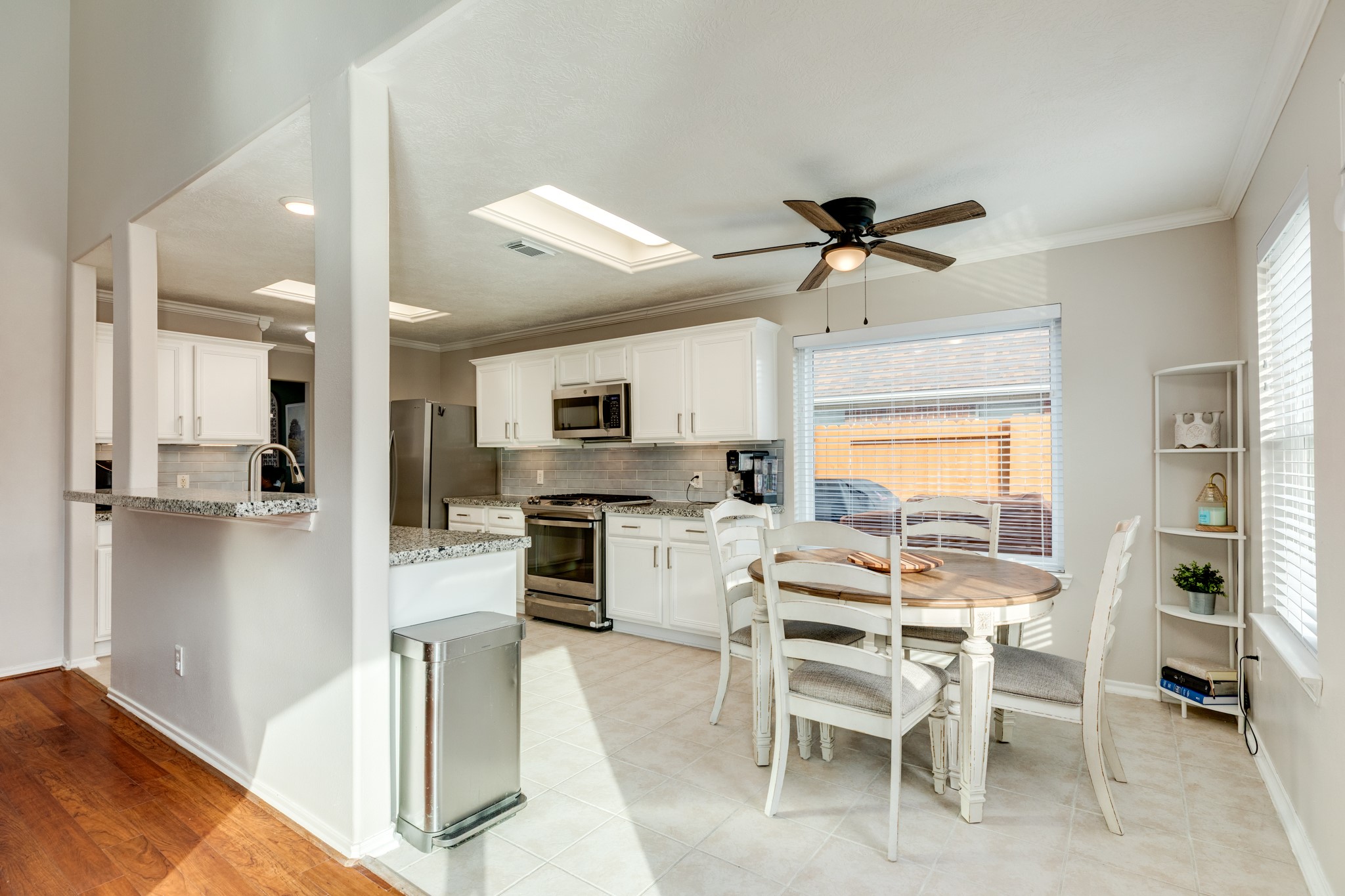 4113 Merlet Drive Pearland, TX 77584 - Photo 15 of 36 This view showcases the breakfast nook, featuring a large window that creates a delightful space for enjoying a morning beverage.