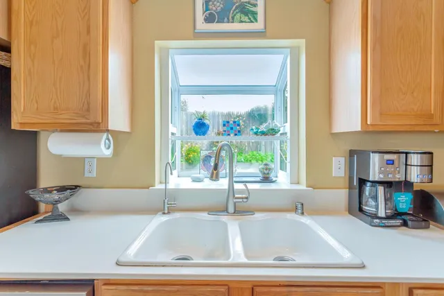 a view of a dining room with furniture a chandelier and window