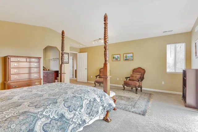 a bathroom with a granite countertop shower a toilet and a shower