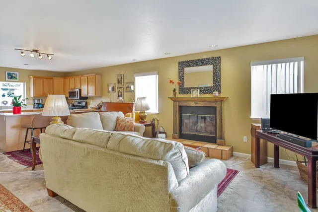 a living room with furniture fireplace and a table