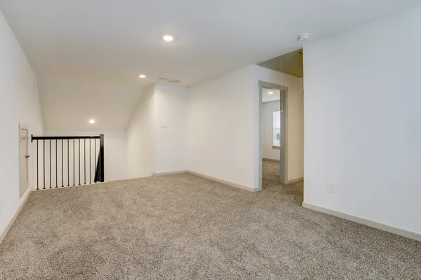 a view of an empty room and wooden floor