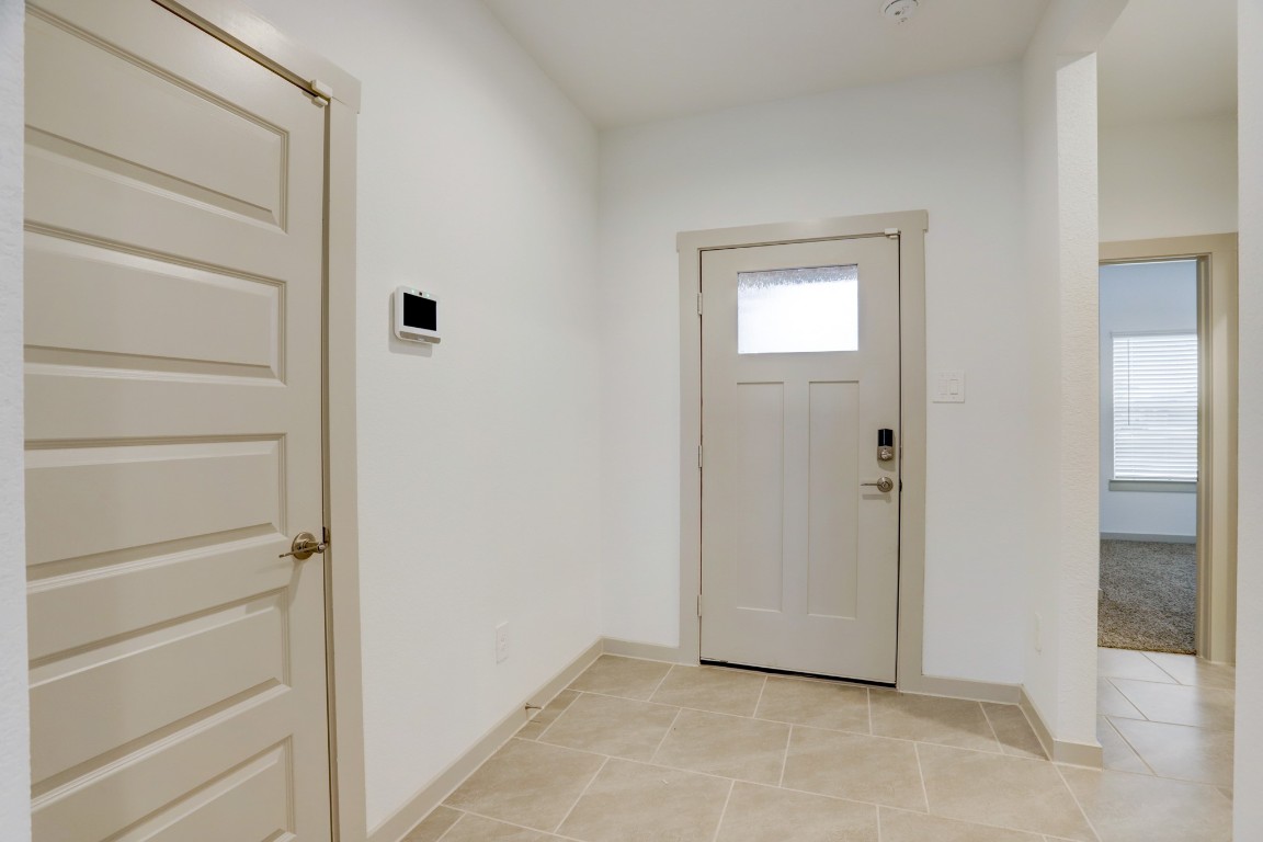 29866 Wildcat Way Katy, TX 77494 - Photo 2 of 25 Bright and welcoming entryway with tall ceilings and elegant tile flooring that sets the tone for the home’s modern interior. Clean lines, neutral tones, and abundant natural light create a warm first impression as you step inside. The foyer offers easy access to the main living areas while providing a spacious transition space that feels open and inviting, perfect for greeting guests and showcasing the home's thoughtful layout and contemporary design.