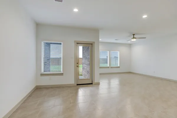 an empty room with windows and closet