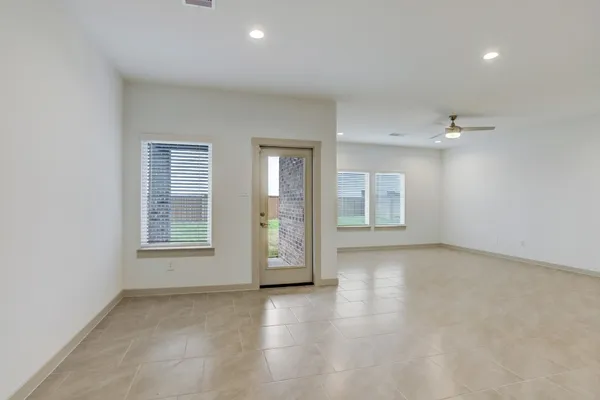 an empty room with windows and closet