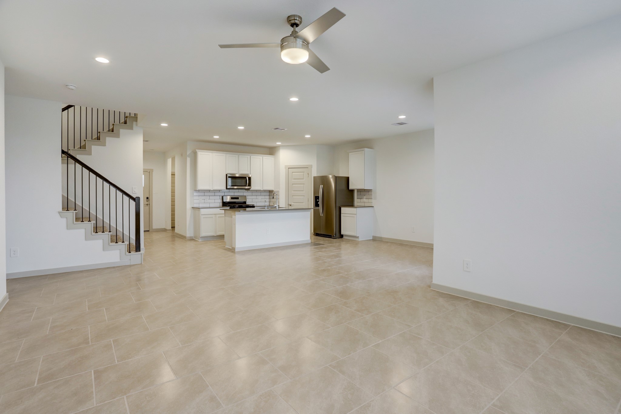 29866 Wildcat Way Katy, TX 77494 - Photo 10 of 25 a view of a kitchen with wooden floor and a ceiling fan