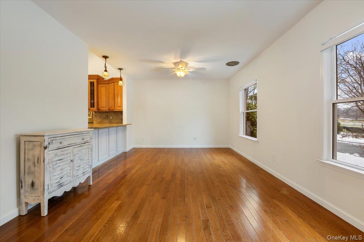 33 Fleets Cove Road Huntington, NY 11743 - Photo 17 of 42 Unfurnished living room with hardwood / wood-style flooring and ceiling fan