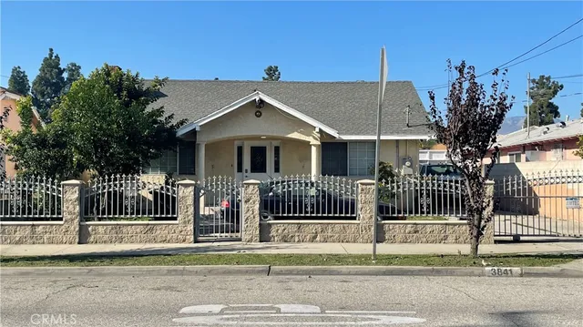 a view of a house with a small yard and plants