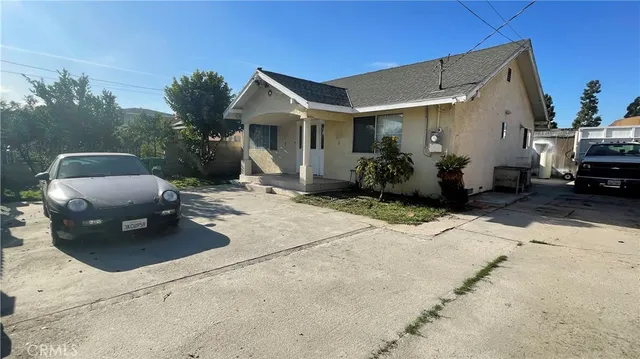 a building outdoor space with patio furniture and potted plants