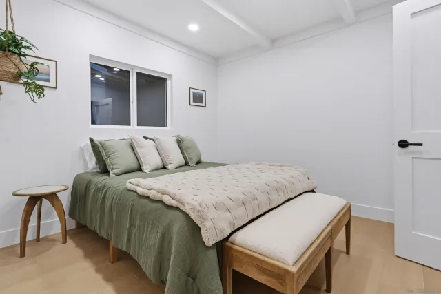 a view of a bedroom with furniture and window