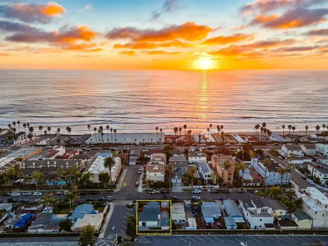 a kitchen with stainless steel appliances granite countertop a stove top oven a sink a dining table and chairs