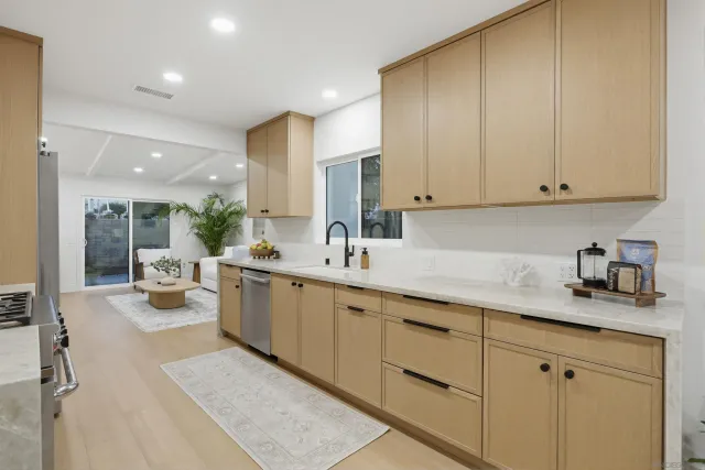 a kitchen with stainless steel appliances granite countertop a sink stove oven and refrigerator