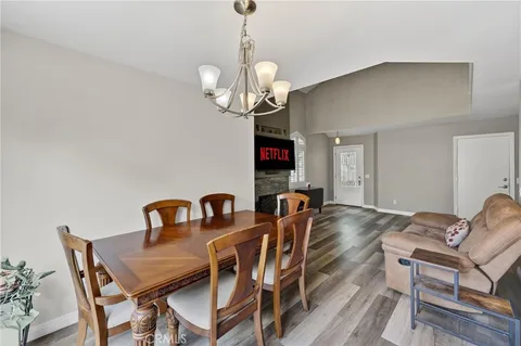 a view of a dining room with furniture wooden floor and a chandelier